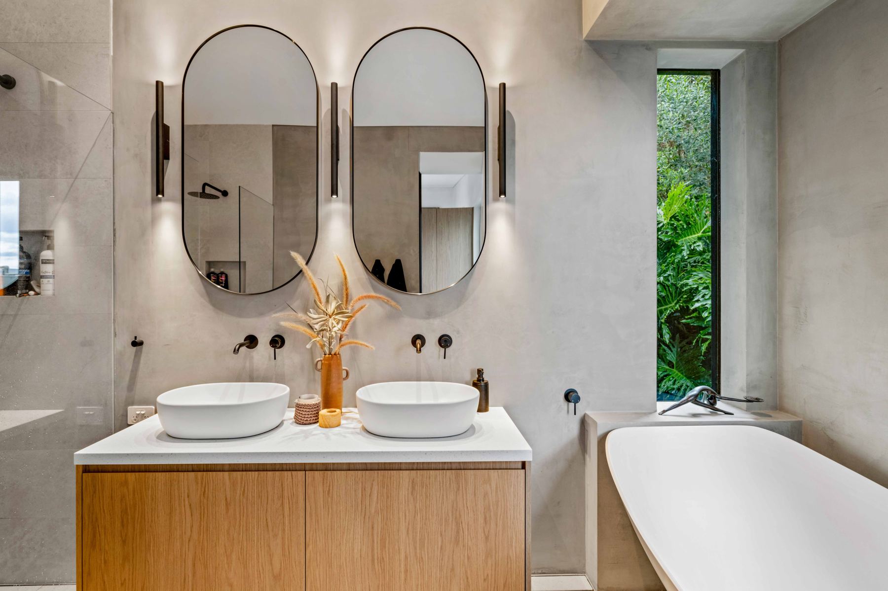 Bathroom with wall lights beside mirrors