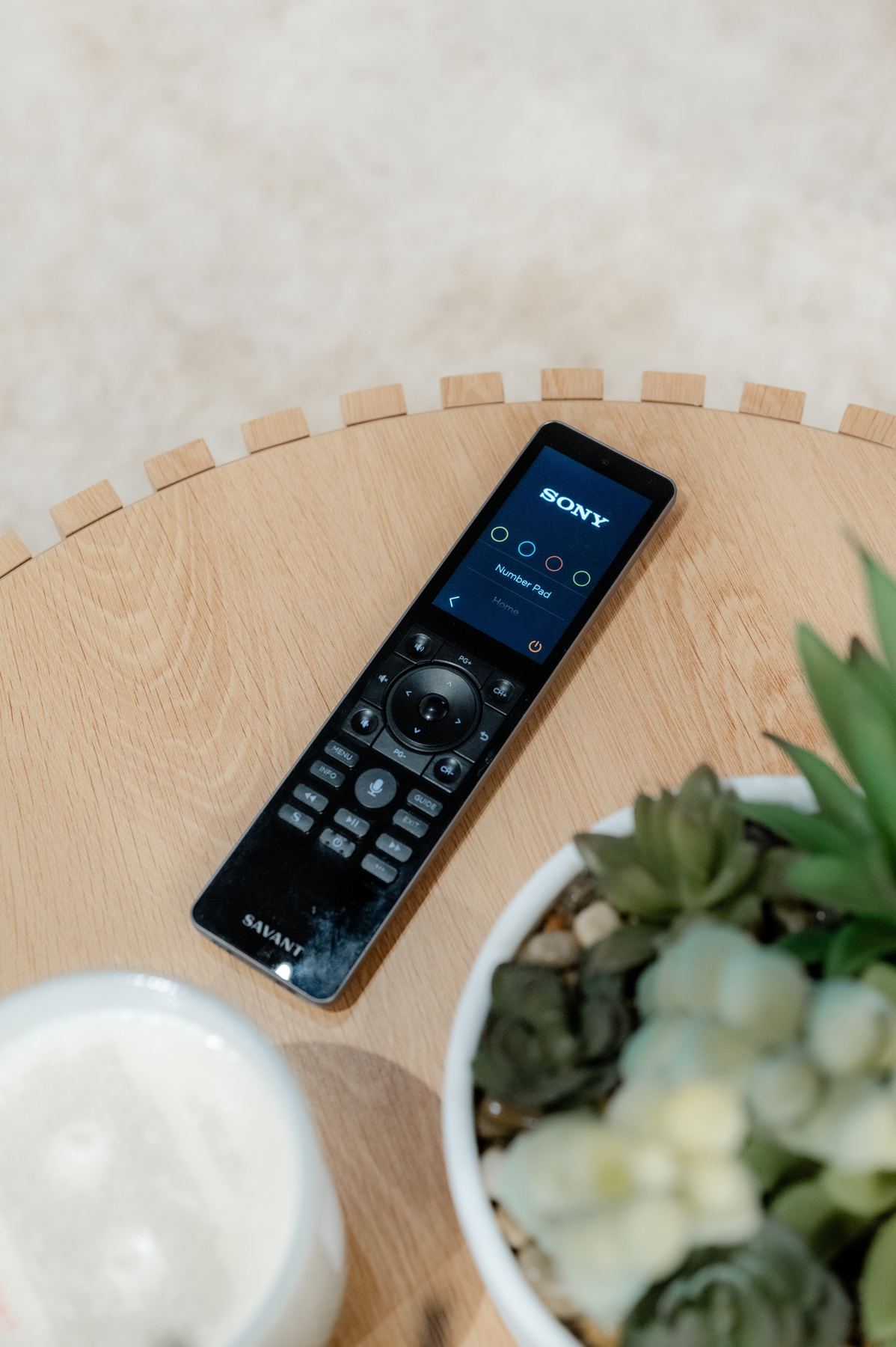 Savant Pro remote on a timber side table